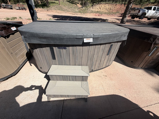 Refurbished Marquis Resort hot tub with cover closed and steps