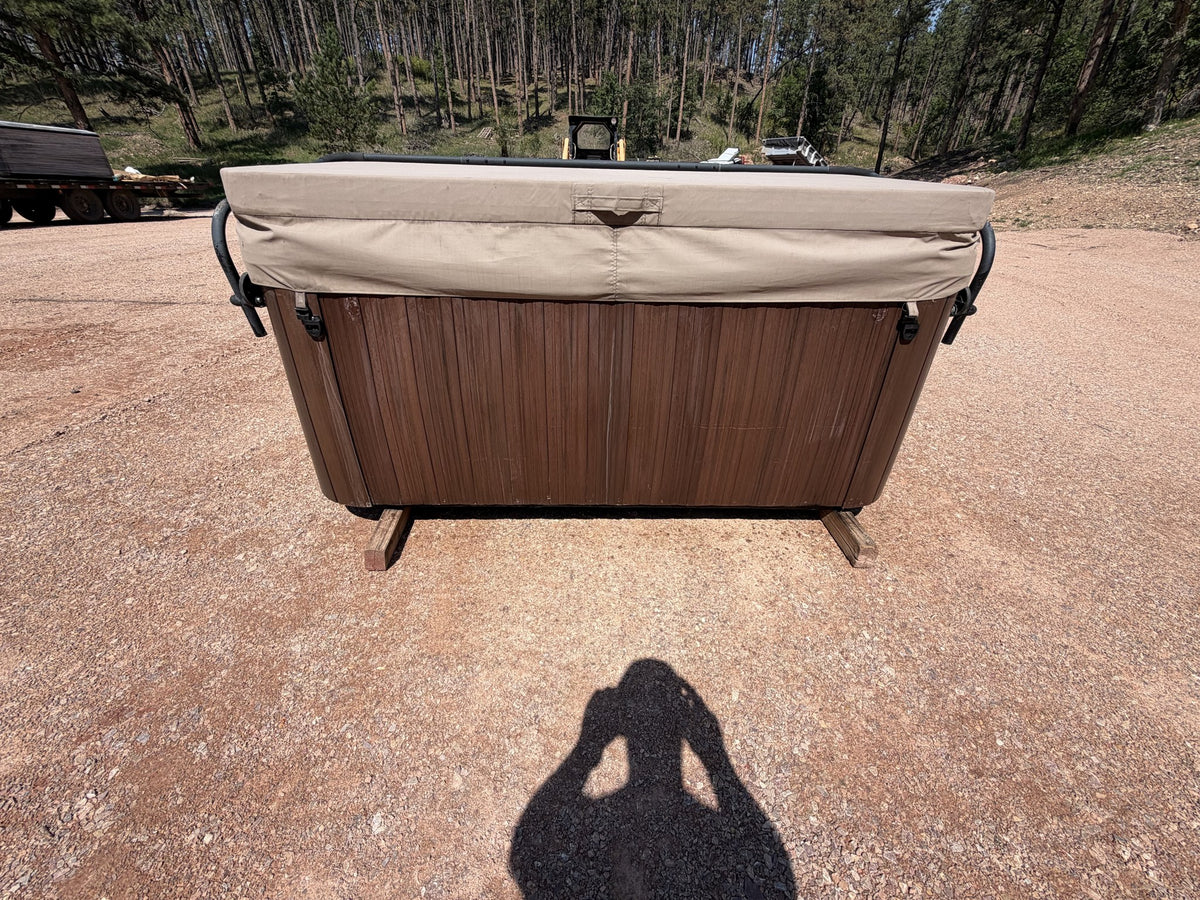 Rear view of the Jacuzzi J-245 hot tub cabinet and cover
