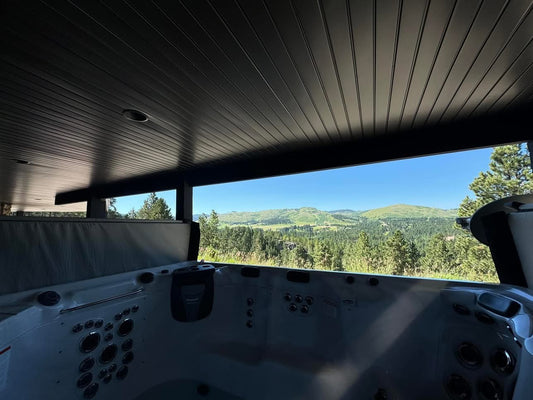 Refurbished H2X Therapool Deep swim spa with the cover open, white shell and perimeter jets, overlooking the Black Hills